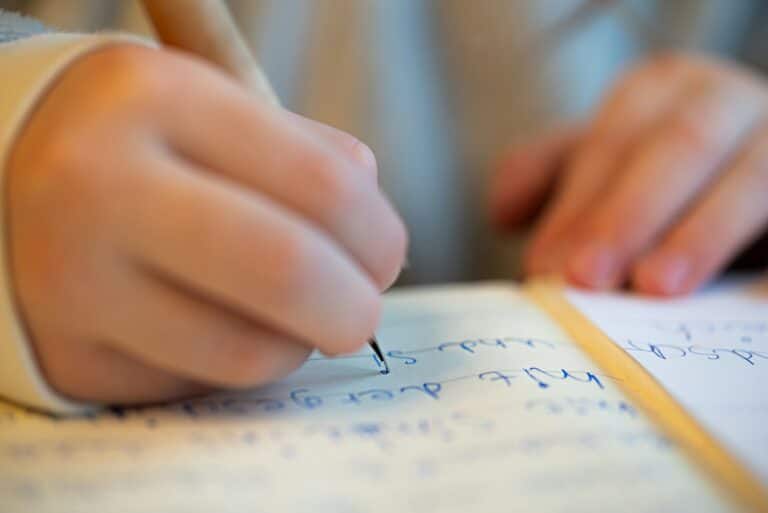 Child writing on a piece of paper